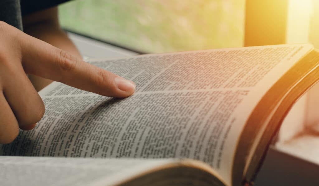 A young woman pointing out the verses of the Scriptures.